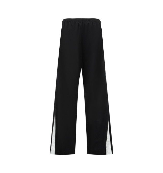 Image 2 of 4 - BLACK - BALENCIAGA NBA Tracksuit Pants featuring technical polyamide, contrasting yokes, mid-waist, elasticated waistband, 2 zipped slash pockets, loop sports icon artwork embroidered on right leg and NBA artwork embroidered on left leg. 100% polyamide. Lining: 100% polyester. Made in Portugal.  