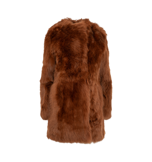 Image 1 of 3 - ORANGE - Toteme Women's Short Silky Shearling Coat Ginger is a statement coat made from soft lamb shearling with long silky hairs for a dramatic take on texture. It has a round neckline, side-seam pockets, and concealed hooks for a clean finish. Main Materials: Lamb shealing/leather, Suede interior. 