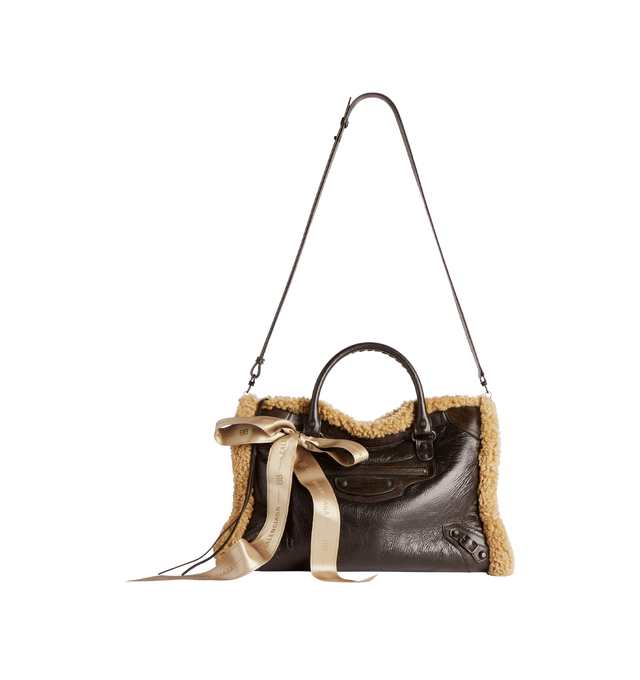 Image 3 of 4 - BROWN - BALENCIAGA Le City Bag Medium in brown calfskin and beige shearling, brass hardware featuring two leather hand-braided handles, adjustable and removable shoulder strap, ribbon with Balenciaga logo on the front, zipped closure with knotted leather puller, front zipped pocket with knotted leather puller, 1 inner zipped pocket and cotton canvas lining. 15.1" x 9.4" x 5.3". Calfskin, shearling, polyester. Made in Italy. 