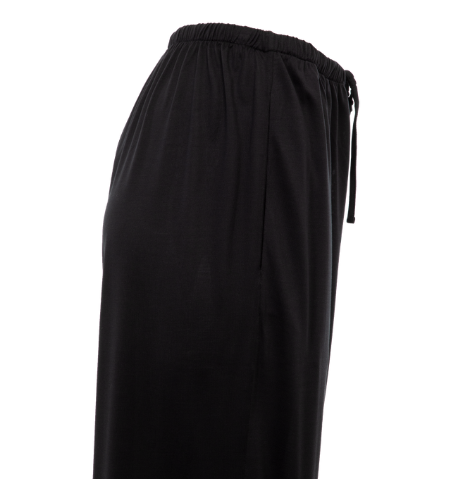 Image 3 of 4 - BLACK - THE ROW Lanuit Pant featuring a mid-rise pull-on pant in smooth silk jersey with relaxed fit, elastic waistband, and side pockets. 100% silk. Made in Italy. 