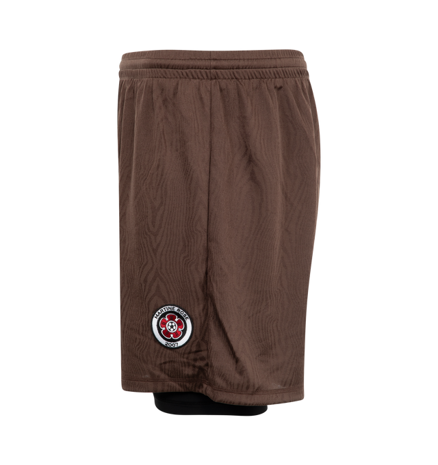 Image 4 of 4 - BROWN - Martine Rose football shorts crafted from dryfit jersey featuring vinyl Martine Rose crest and logo, elasticated waist, built-in elasticated tights designed to show just below the hem. Unisex style in men's sizing. 100% polyester with 59% polyamide / 41% elastane lining. 