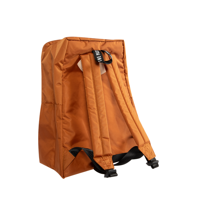 Image 2 of 3 - BROWN - HUMAN MADE Daypack featuring lightweight nylon Oxford exterior, PVC heart logo on the front, two-way zip closure, logo printed on top handle, front zip pocket, shoulder strap features a leather brand logo panel and one interior laptop sleeve. Capacity: around 20 L. 39cm x 34cm x 17cm. 