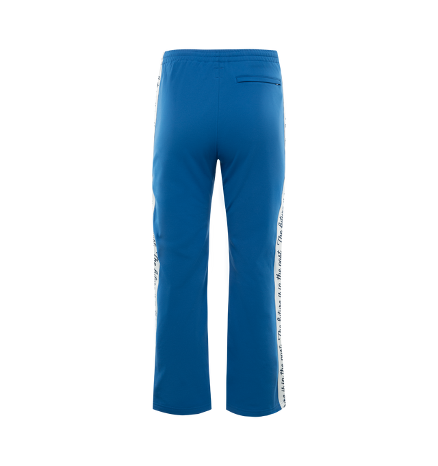 Image 2 of 3 - BLUE - HUMAN MADE Track Pants featuring the character graphic of "THE FUTURE IS IN THE PAST" on both sides, elastic waist, two side pockets and one back welt pocket. 100% polyester. 