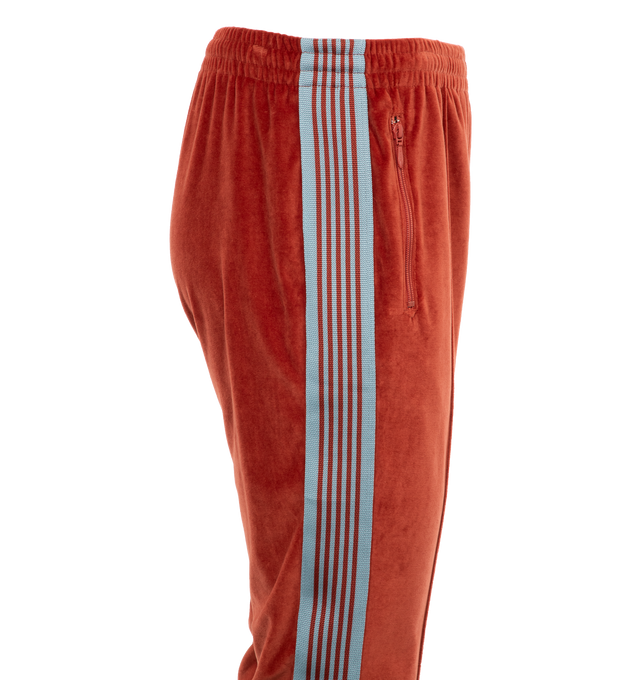 Image 3 of 4 - RED - NEEDLES Narrow Track Pants featuring cotton-blend velour, concealed drawstring at elasticized waistband, three-pocket styling, logo graphic embroidered at front, pinched seam at legs, striped webbing trim at outseams, creased legs at back and unlined. 77% cotton, 23% polyester. Made in Japan. 