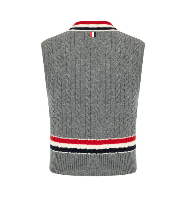 Image 2 of 2 - GREY - Thom Browne Mens Wool V-Neck Vest is crafted from cashmere and features a classic V-neck, signature RWB stripe detailing at the neckline and hem, buttoned side vents, buttoned rib-knit trim with signature striped grosgrain accents, and the signature striped grosgrain loop tab at the back. This designer cashmere sweater vest combines traditional Aran cable knit construction with iconic Thom Browne detailing for elevated everyday layering. Main Material: Wool. Made in Italy. 