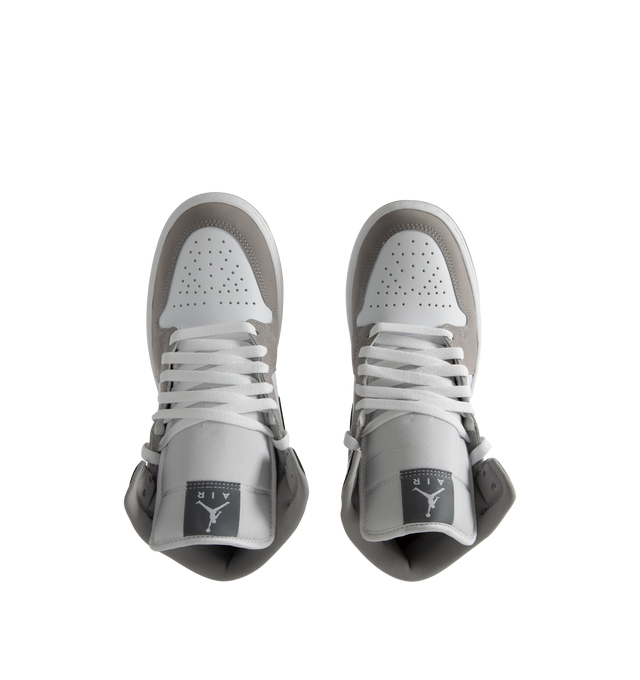 Image 5 of 5 - WHITE - Jordan Air Jordan 1 Mid SE Sneakers are a lace-up, high-top style with real and synthetic leather uppers, Nike Air technology cushioning, logos on the collars and tongues, padded, mid-top collars, and rubber outsoles.  