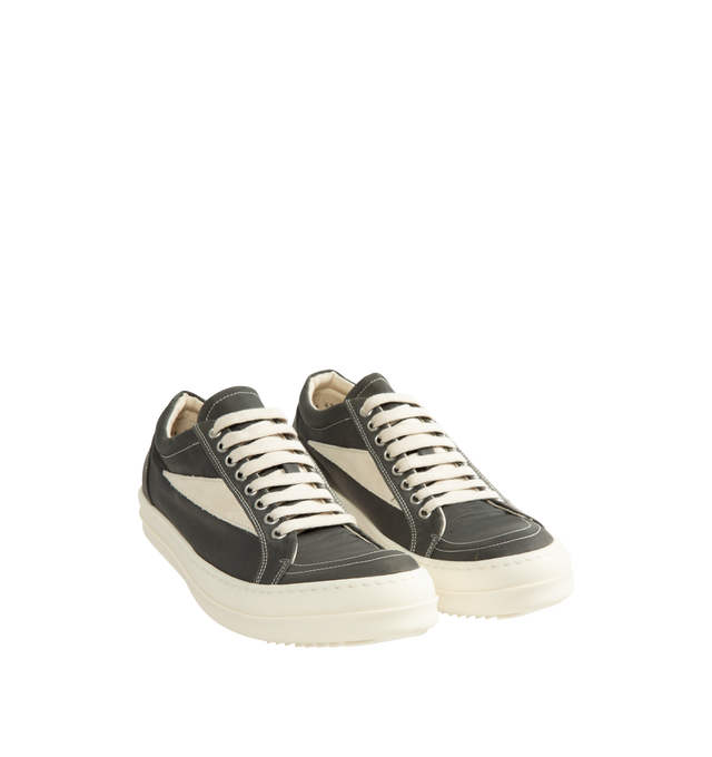 Image 2 of 5 - GREY - Rick Owens DRKSHDW Vintage Sneaks are designed with a low-top design including a lace-up closure, signature shark-tooth soles, and contrast stitching. The medium-weight denim is overdyed for a soft, washed handfeel, while the fabric undergoes responsible treatment processes designed to reduce water consumption. Upper: 100% Cotton. Lateral Details: 100% Calf Leather. Lining: 100% Cotton. Sole: 100% Thermoplastic Rubber. Sole Height: 3.5 cm / 1.4 in. Closure: Lace-Up. Made in Italy. 