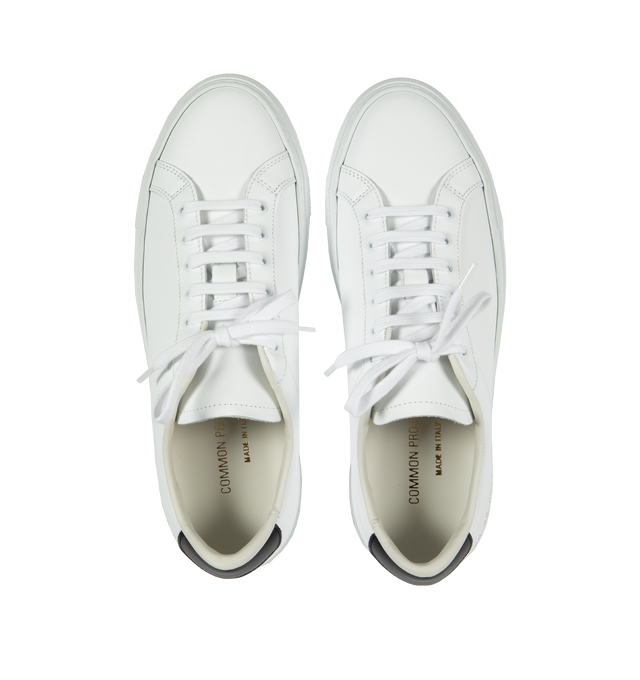 Image 5 of 5 - WHITE - Common Projects  Retro Classic Leather Lace-Up Sneakers in a minimal design crafted from white calf leather with black leather tabs at the heels, detailed with signature gold stamped serial numbers. 