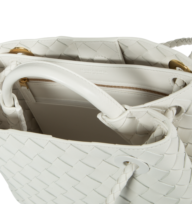 WHITE - BOTTEGA VENETA Small Andiamo featuring leather top handle, sliding cross-body strap, compartmented interior with one zippered pocket, two open pockets and magnetic closure. 7.9" x 9.8" x 3.9". 100% lambskin. Made in Italy.