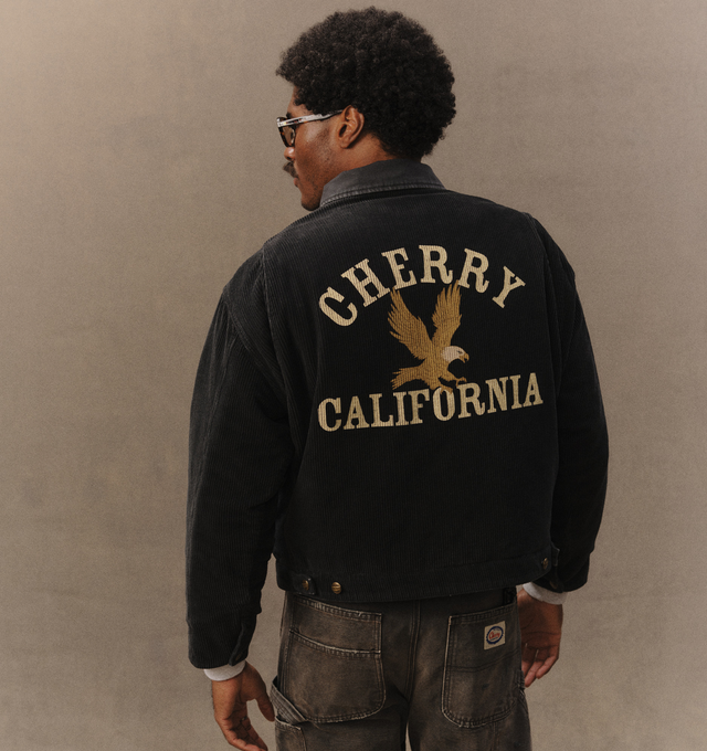 Image 7 of 7 - BLACK - Cherry LA Men's Corduroy Work Jacket is crafted from cotton corduroy and features a vintage-washed finish, a canvas collar, and a nickel zip closure at the front. Designed with double welt chest pockets with zip closures, side welt pockets, distressed detailing, and a screen-printed graphic at the back, this workwear-inspired style is finished with custom branded hardware and a removable eagle pin at the collar. Main Material: Cotton. Made in Los Angeles, USA. 