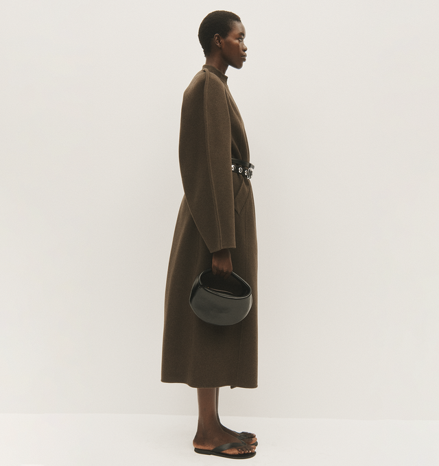 Image 4 of 5 - BROWN - Khaite Rothen Coat has a wrap front silhouette with raglan sleeves, an inverted back pleat, and a sash belt. 100% wool.  