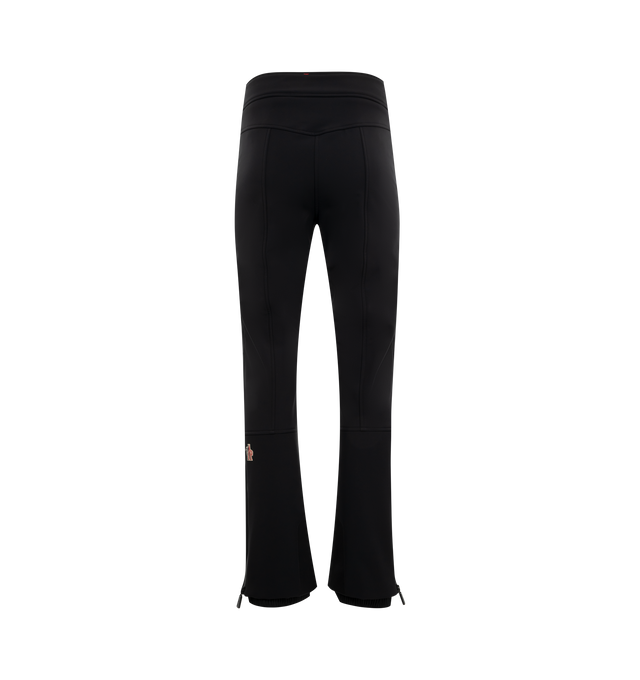 Image 2 of 3 - BLACK - Moncler Grenoble Padded Technical Wool Ski Pants have an adjustable waistband with a YKK AquaGuard water-resistant zipper and snap button closure, heat-sealed seams, side pockets, cargo pockets, stretch technical nylon lining, PrimaLoft Gold Insulation Active, RECCO reflector, powder cuffs, a ski cut hem protector, and embossed and bonded logo details. Water repellent.  