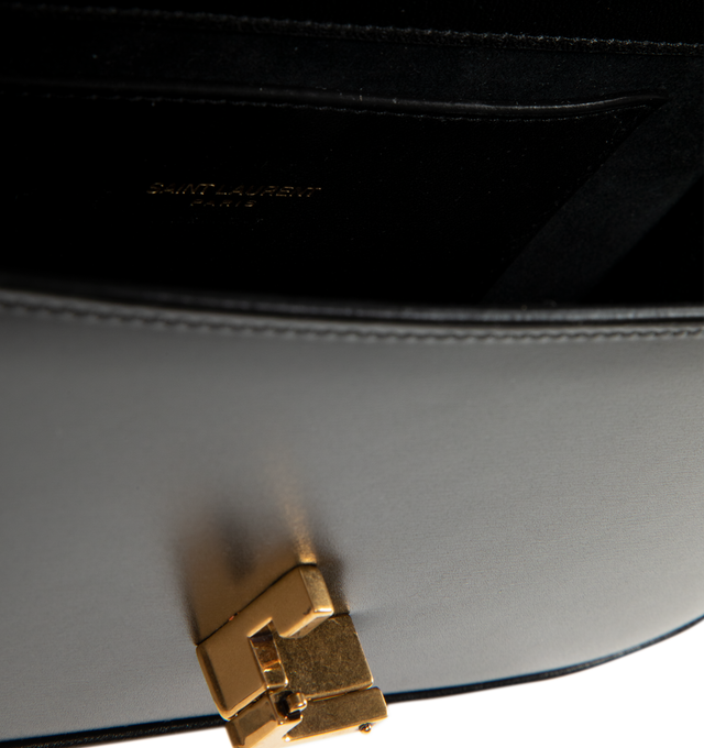 Image 3 of 3 - BLACK - Saint Laurent Women's Mini Top-Handle Bag is crafted from box calfskin leather and features the iconic Cassandre sliding clasp closure, a structured top handle, a detachable and adjustable shoulder strap, bronze-tone hardware, a suede-lined interior, one card slot, and a rear flat pocket. This designer leather top-handle bag combines timeless elegance with versatile styling for day-to-evening wear. Main Material: Calfskin Leather. Lining: Suede. Hardware: Brass. Dimensions: 19.5 x 11. 