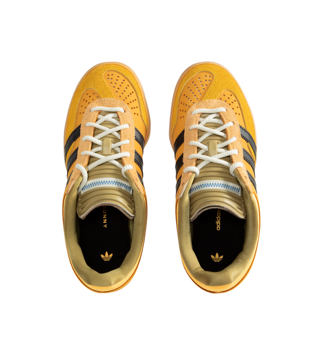 Image 5 of 5 - YELLOW - Adidas Originals x Bad Bunny Men's Gazelle Indoor Shoes feature the latest release from the ongoing adidas Originals by Bad Bunny collaboration, reimagining the iconic Gazelle Indoor silhouette through the artist's distinctive creative lens. Crafted with a premium leather upper, this statement sneaker combines heritage terrace style with contemporary design details, while a textile lining enhances comfort and a durable gum outsole provides everyday traction. Main Material: Leather Up 