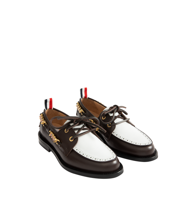Image 2 of 4 - BROWN - THOM BROWNE Brogue Leather Boat Shoes featuring two-tone leather with a refined brogue-style perforated panel, classic silhouette, a chain-link trim interwoven with the houses signature stripes, almond toe, slips on, leather upper, leather lining and rubber sole. Made in Italy. 