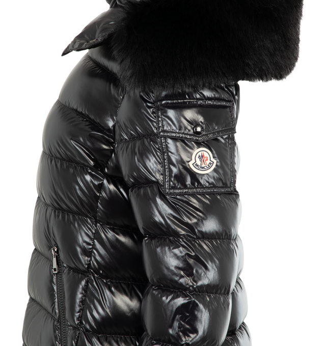 Image 4 of 4 - BLACK - MONCLER Badyf Faux Fur-Trimmed Hooded Short Down Jacket featuring nylon laqu lining, down-filled, detachable faux fur trim, detachable and adjustable hood, zipper closure, flap sleeve pocket, zipped pockets and adjustable cuffs. 100% polyamide/nylon. Padding: 90% down, 10% feather. 