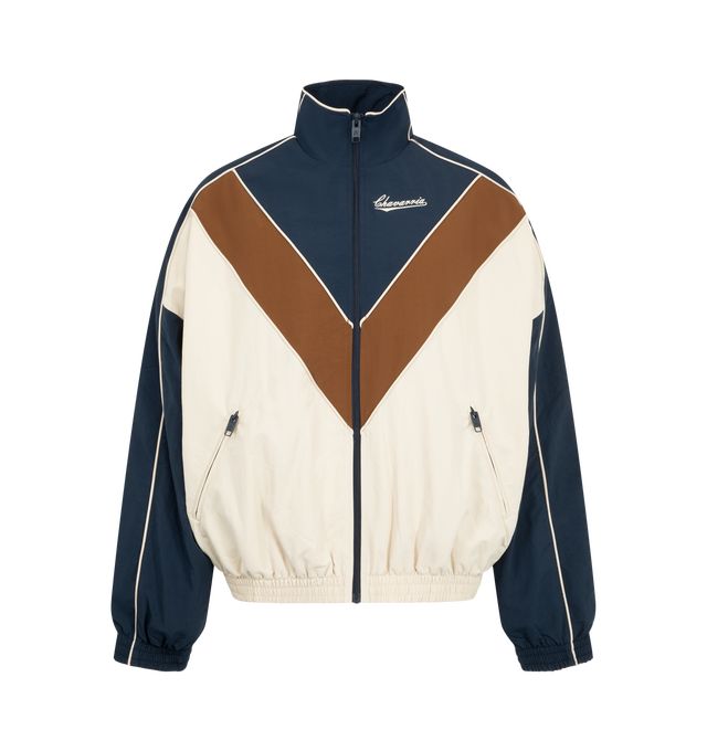Image 1 of 3 - MULTI - Willy Chavarria Bad Boy Track Jacket is crafted from nylon and features a sleek, true-to-size silhouette defined by bold chevron paneling and contrast piping. Designed with a stand collar, front zip closure, two zippered pockets, stacked script logo detailing, and elasticized cuffs and hem. Main Material: 100% Nylon. Lining: Polyester. 