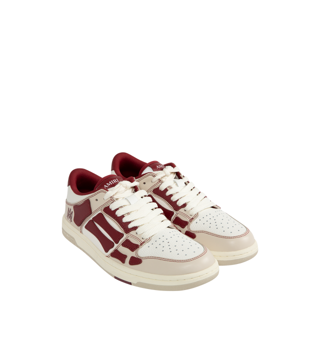 Image 2 of 5 - RED - Amiri Varsity Skel Top Low Sneakers are a lace-up style with perforation details, signature graphics, leather appliques, and two-tone rubber soles. Leather uppers. Made in Vietnam.  