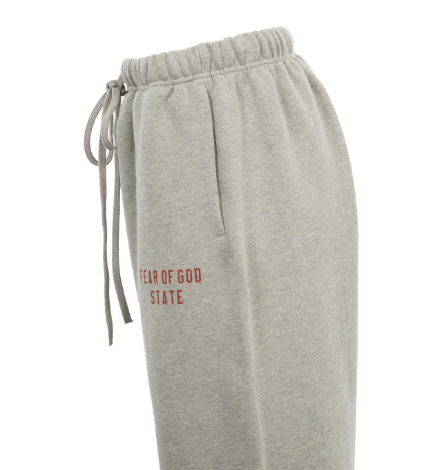 Image 3 of 3 - GREY - Fear of God Drawstring Fleece Sweatpants have an elastic drawstring waist, side seam pockets, elastic hems, and logo details. 83% cotton, 17% recycled polyester fleece.  