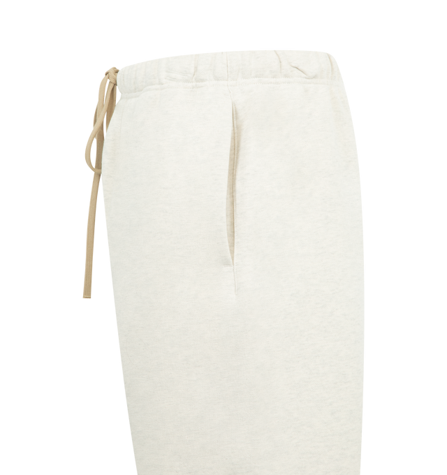 Image 3 of 3 - WHITE - FEAR OF GOD ESSENTIALS Flare Sweatpant featuring 480gsm core fleece, relaxed silhouette that extends into a flared leg, encased elastic waistband with elongated drawcords, side seam pockets and a Fear of God Essentials rubberized label stitched at the center front. 80% cotton, 20% polyester. 