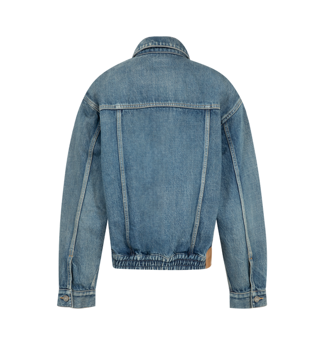 Image 2 of 3 - BLUE - Saint Laurent Womens Jean Jacket is crafted from certified cotton denim. Features a loose fit, button-front closure, pointed collar, buttoned flap chest pockets, front welt pockets, one-button cuffs, cotton lining, and embossed Saint Laurent Paris leather jacron. Main Material: 100% Cotton; Lining: Cotton. Made in Japan. 