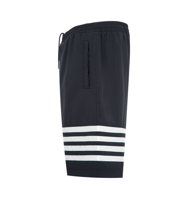 Image 3 of 3 - BLUE - Thom Browne Mens Track Shorts are crafted from shiny ripstop fabric. Feature a relaxed fit, elasticized drawstring waistband with signature RWB aglets, zip fly, welt hand pockets, welt back pocket, mesh lining, engineered 4-bar detailing, and signature striped grosgrain loop tab. Main Material: 81% Polyamide, 19% Polyester; Lining: 100% Polyester. Made in Italy. 