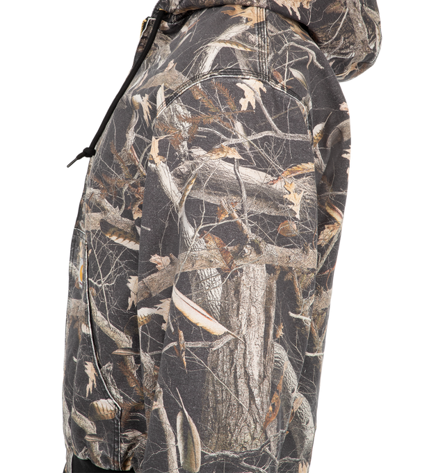 Image 3 of 3 - MULTI - Carhartt WIP Men's OG Active Jacket is crafted from heavyweight Dearborn canvas and features this season's allover Camo Feather Tree print, an adjustable hood, and a front zip closure. Designed in the brand's original loose fit, it is detailed with a diamond-quilted lining, kangaroo pocket, inside chest pocket, rib-knit cuffs and hem, triple-stitched construction, and a woven Square Label. Main Material: 100% Organic Cotton Dearborn Canvas. 