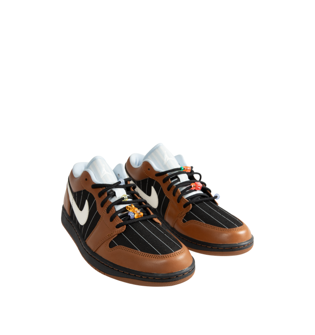 Image 2 of 5 - BROWN - Men's Air Jordan 1 Low SE Sneakers feature a genuine leather and suede upper with the iconic low-top silhouette, signature Wings branding, and a Jumpman logo for a premium take on a timeless classic. These lifestyle sneakers combine encapsulated Air-Sole cushioning with a durable rubber outsole for lightweight comfort, lasting support, and reliable everyday traction. Main Material: Genuine Leather and Suede. Midsole: Encapsulated Air-Sole Unit. Sole: Rubber. 