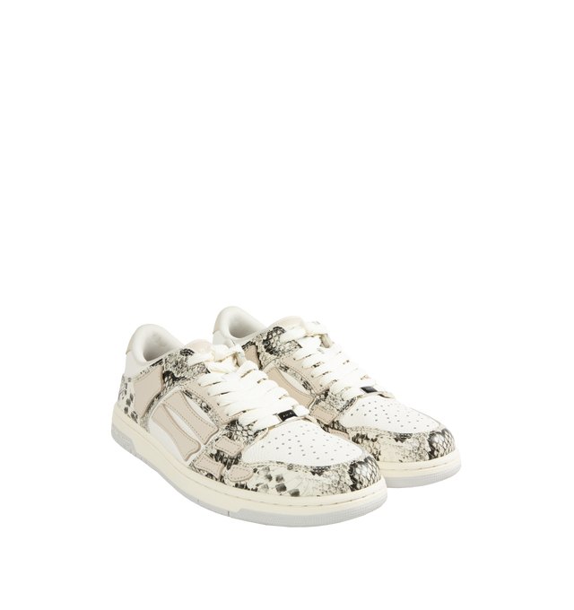 Image 2 of 5 - WHITE - AMIRI Skel Snake-Embossed Low-Top Sneakers featuring matte and snake-embossed leather, flat heel, round toe, lace-up vamp, logo on the tongue and heel, padded collar, skeleton motif on the side and rubber outsole.  