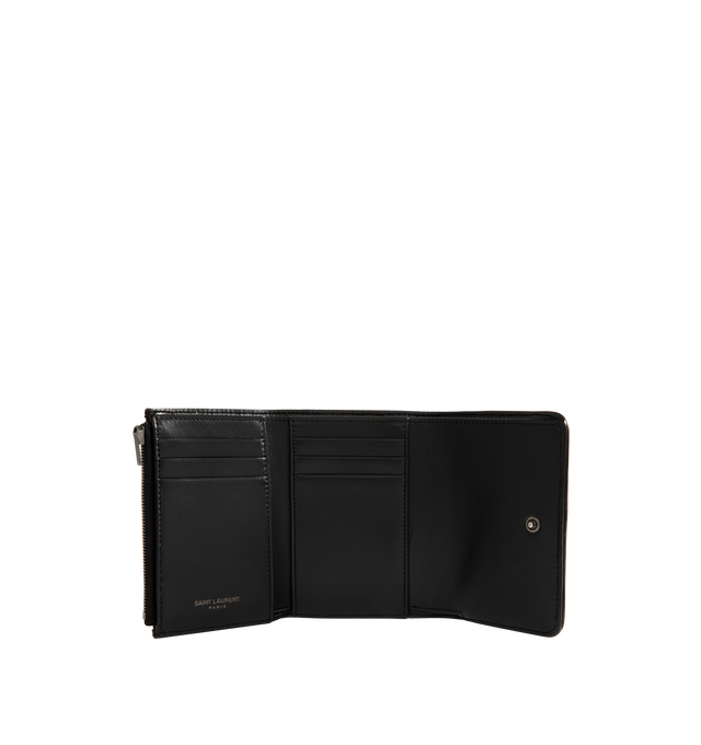 Image 3 of 3 - BLACK - Saint Laurent Womens Tri-Fold Wallet is crafted from calfskin leather. Features signature CASSANDRE hardware, quilted topstitching, snap-button closure, six card slots, one bill compartment, one zip coin pocket, and bronze-tone hardware. Dimensions: 12  11.5  2.5 cm. Main Material: Calfskin Leather; Hardware: Brass. Made in Italy. 