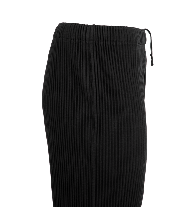 Image 6 of 6 - BLACK - ISSEY MIYAKE August Pant featuring a short length, pockets on both sides, draw cord at the waist and a button-fly design. 100% polyester. Made in the Philippines. 
