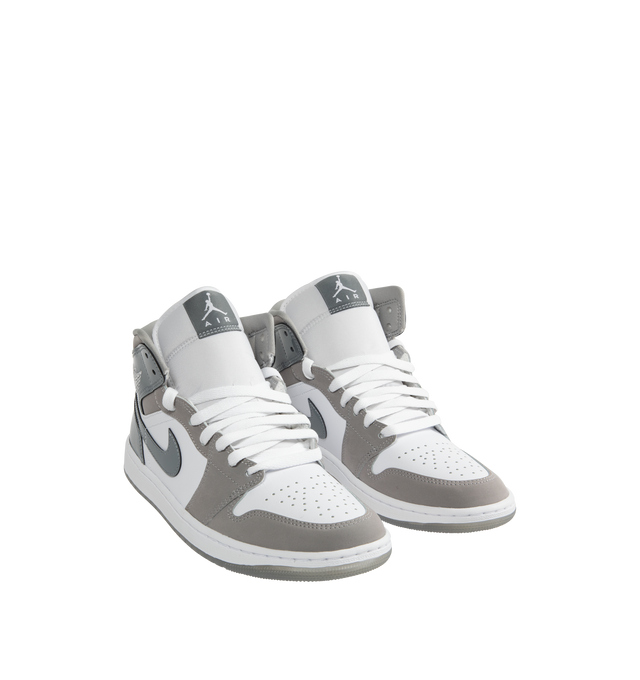 Image 2 of 5 - WHITE - Jordan Air Jordan 1 Mid SE Sneakers are a lace-up, high-top style with real and synthetic leather uppers, Nike Air technology cushioning, logos on the collars and tongues, padded, mid-top collars, and rubber outsoles.  