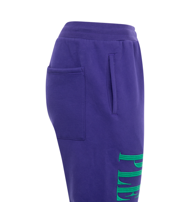 Image 3 of 3 - PURPLE - Pleasures Onyx Sweatpants have an elastic drawstring waist, side pockets, a back patch pocket, logo embroidery, and elastic cuffs. 57% cotton, 43% polyester.  