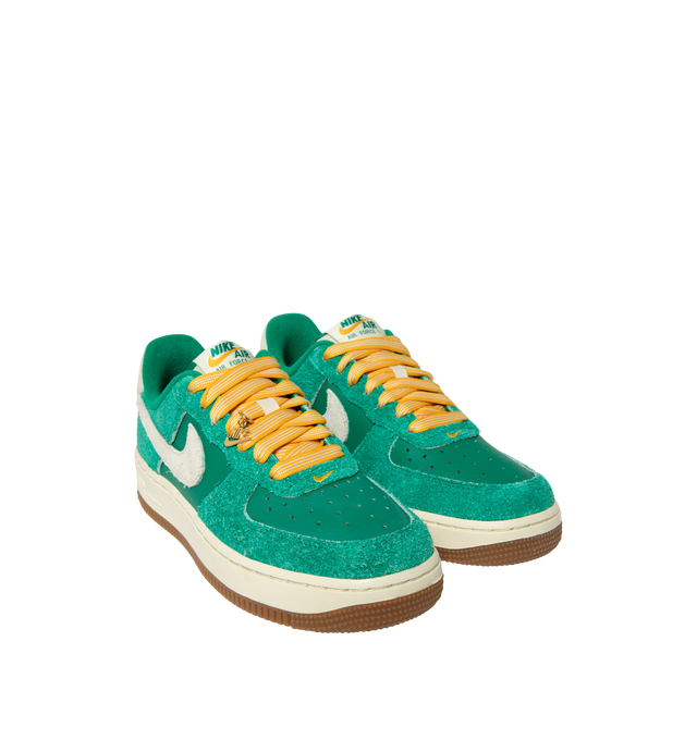 Image 2 of 5 - GREEN - Nike Women's Air Force 1 07' Game Day Sneakers feature a genuine and synthetic leather upper with a perforated toe box for breathable comfort and a timeless look. These iconic lifestyle sneakers combine lightweight Nike Air cushioning, a padded collar, and a durable rubber outsole with classic pivot-circle traction for everyday wear. Clip-on charms add a customizable finishing touch. Main Material: Genuine Leather and Synthetic Leather. Midsole: Foam with Nike Air Unit. Sole: Rubber.  