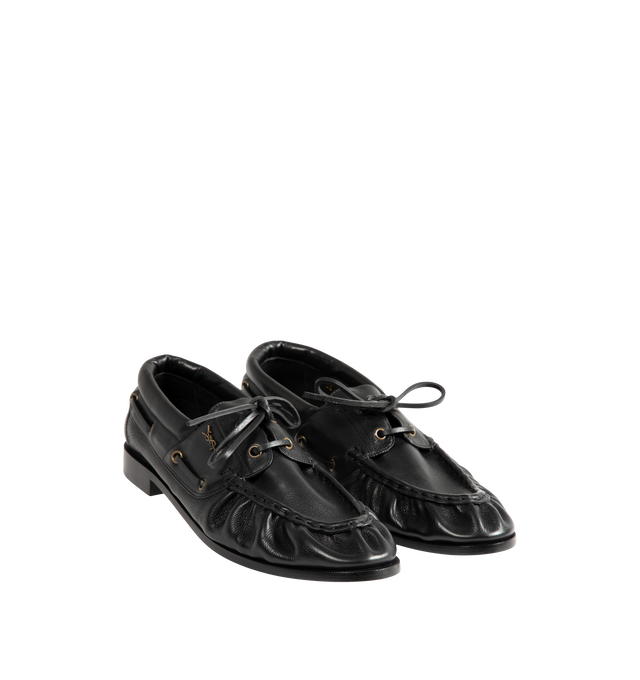 Image 2 of 4 - BLACK - Saint Laurent Mens Boat Shoes are crafted from metal-free tanned calfskin leather. Feature a lace-up boat shoe silhouette, hand-stitched moc toe, gold-tone CASSANDRE hardware, leather sole, and 1.5 cm heel height. Main Material: Calfskin Leather; Hardware: Brass; Sole: Leather. Made in Italy. 