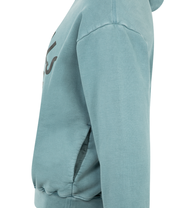 Image 3 of 3 - BLUE - FEAR OF GOD ESSENTIALS Campus 90s Hoodie 520GSM heavy fleece, pigment dyed, cropped, relaxed silhouette, exaggerated proportions with dropped shoulders for a relaxed drape, Essentials Fear of God campus puff-print graphic, side pockets, rib-knit cuffs, waist-hem and Fear of God Essentials label on the hood. 100% cotton. 