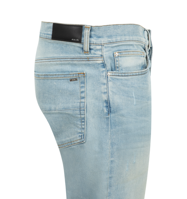 Image 3 of 3 - BLUE - Amiri MX1 Skinny Jeans are a 5-pocket style with a button and zip fly, distressing and rips overall, and a fitted silhouette with skinny legs. Polyester and elastane.  