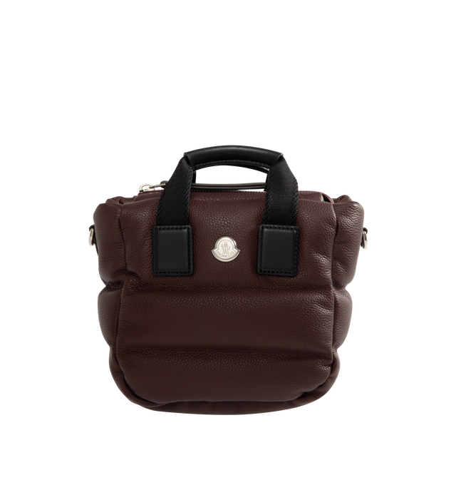 Image 1 of 3 - RED - Moncler Womens Micro Caradoc Shoulder Bag is crafted from leather exterior with signature horizontal boudin quilting. Features cotton drill lining, padded construction, ribbon top handles with leather grip, adjustable and detachable leather shoulder strap, zip closure, and metal Moncler logo. Lining: 100% Cotton; Padding: 90% Down, 10% Feather; Leather Exterior: Cow Leather. Dimensions: 16.5cm L x 13cm H x 8cm D. Made in Italy. 