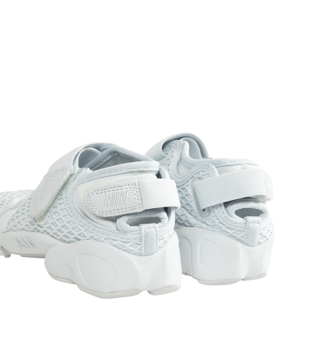 Image 3 of 5 - WHITE - Nike Women's Air Rift Sneaker featuring hook-and-loop straps on the midfoot and heel, Nike Air unit in the heel combined with plush foam, rubber detailing on the outsole, upper features a blend of elastane, polyester and nylon materials for a flexible fit and split toe design. 