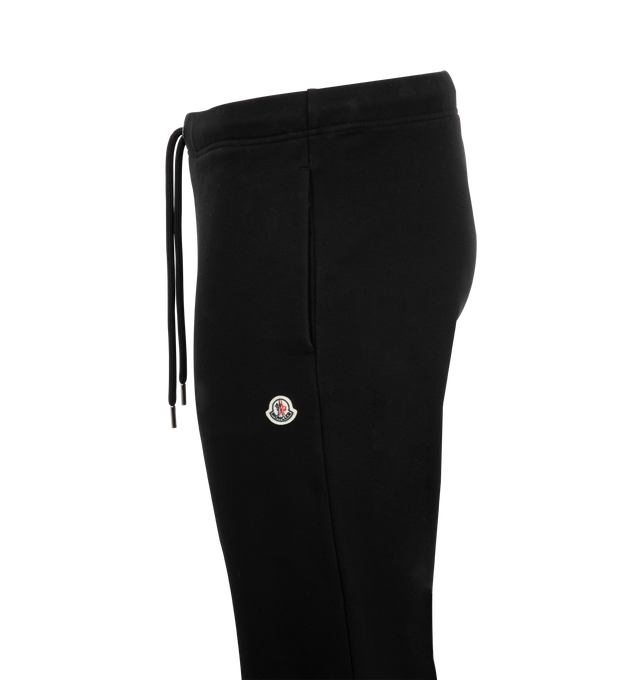 Image 3 of 3 - BLACK - MONCLER Logo Patch Cotton Sweatpants featuring cotton fleece, waistband with drawstring fastening, side pockets and back pocket with snap button closure. 100% cotton. Made in Turkey. 
