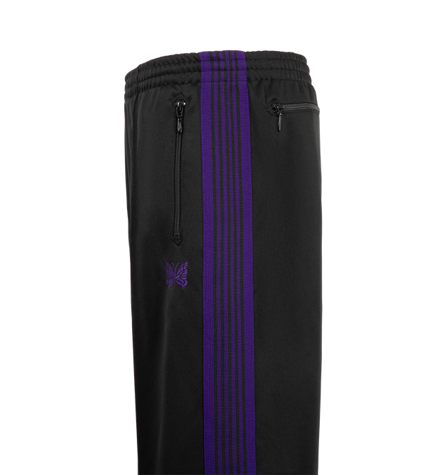 Image 3 of 3 - BLACK - Needles Men's Track Pant - Poly Smooth is crafted from smooth polyester jersey and features the brands signature track pant silhouette with side stripe detailing and embroidered branding. Designed for a relaxed fit, this athletic-inspired style combines comfort and versatility with a streamlined profile and elasticized waistband. Main Material: Polyester. Fit: Relaxed. Waist: Elasticized. Details: Side Stripes, Embroidered Logo. Made in Japan. 