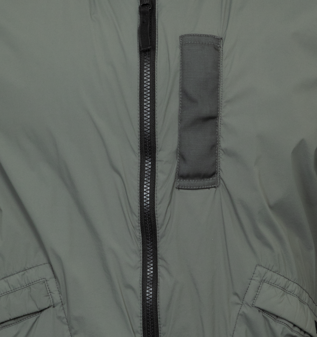 Image 3 of 3 - GREEN - STONE ISLAND Bomber Jacket featuring rib knit stand collar, hem, and cuffs, two-way zip closure, welt pockets, detachable logo patch at sleeve and full taffeta lining. 89% polyamide, 11% elastane. Made in Indonesia. 