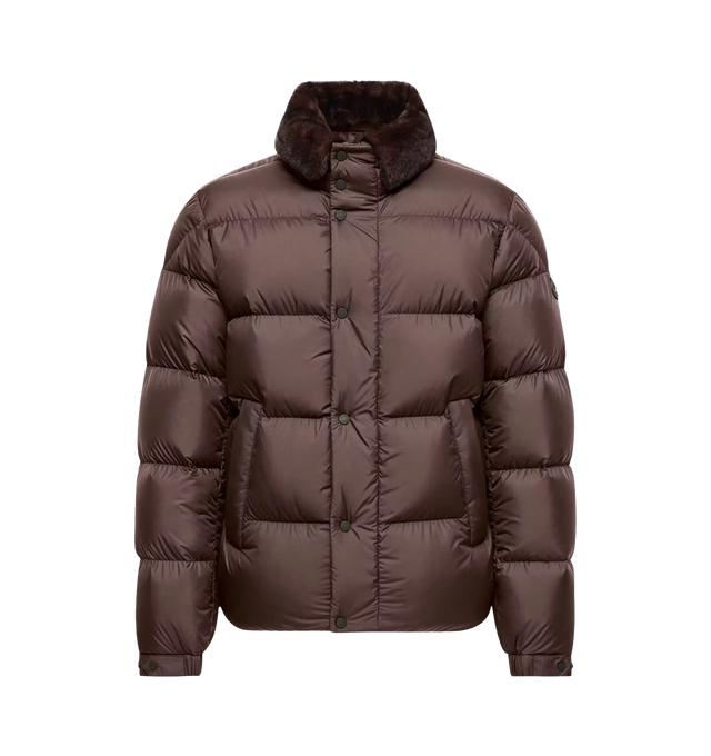 Image 1 of 1 - BROWN - Moncler Men's Drisfall Short Down Jacket is crafted from lightweight AirSoft fabric and features a regular-fit silhouette with fitted shoulders and chest, a boxy waistline, and down-filled insulation. Designed as a versatile everyday layer, this water-repellent style is finished with a textured contrast collar, a zip and snap-button front closure, zipped exterior and interior pockets, adjustable cuffs, and a drawstring hem for a customizable fit. A signature leather logo patch complet 