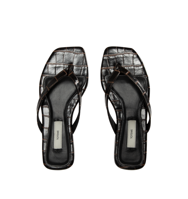 Image 4 of 4 - BROWN - Toteme Women's Croco-Embossed Flip-Flops are crafted from croc-embossed leather and feature a minimalist thong silhouette with an open square toe. Designed with a padded sheepskin footbed featuring a subtle logo patch, these designer sandals are finished with a calfskin leather sole for a refined take on an everyday warm-weather essential. Part of Toteme's Garderob collection. Upper: Leather. Footbed: Sheepskin. Sole: Calfskin Leather. Color: Dark Brown. Made in Italy. 