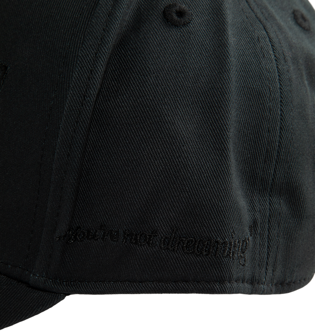Image 3 of 3 - BLACK - Midnight Rodeo Blackout "Classic" Trucker Hat is crafted from cotton twill and features the brand's signature Midnight Rodeo logo embroidered at the front, "You're Not Dreaming" embroidery at the side panel, and an MR logo embroidered at the back. Designed with an adjustable fit and detailed embroidery throughout, this classic trucker-style cap is finished with a custom lining featuring Midnight Rodeo branding. Main Material: Cotton Twill. 