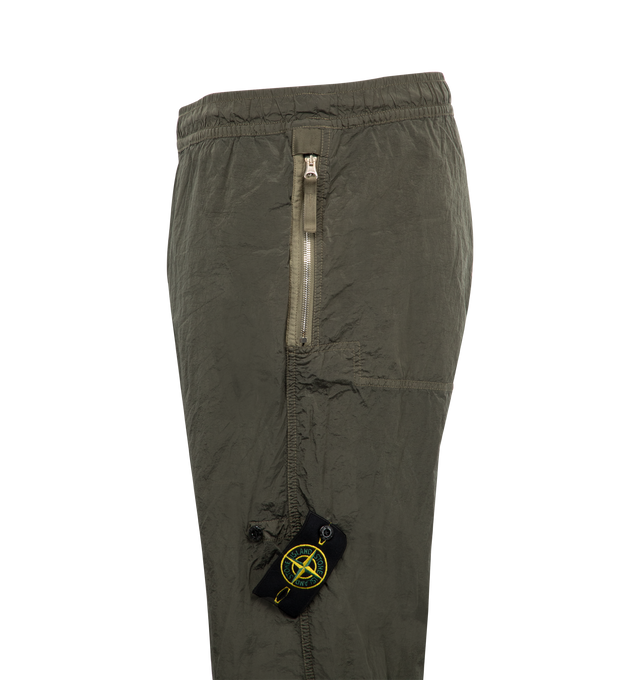 Image 3 of 3 - GREEN - Stone Island Pull-On Pants have an elastic waist, side zip pockets, a signature snap-on logo patch, drawing ankles, and side cargo pockets.  