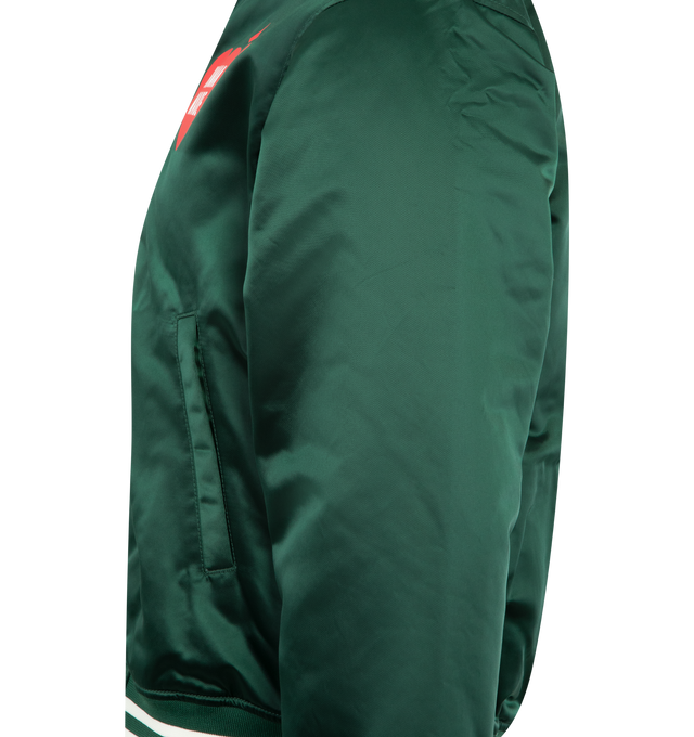 Image 3 of 3 - GREEN - HUMAN MADE Nylon Stadium Jacket featuring quilted polyester lining, ribbed collar, logo snap buttons, 2 front pockets and branding throughout. 100% nylon. 