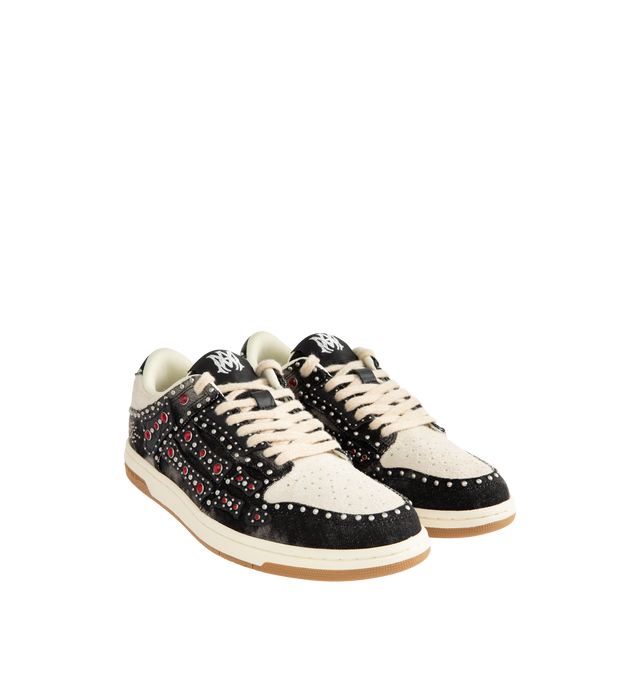 Image 2 of 5 - BLACK - AMIRI Stud Skel Top Low Sneaker featuring bone appliques, stud detailing, two-tone rubber sole with an upper paneled with washed denim and textured suede. 95% cotton, 5% polyester. Sole: rubber. 