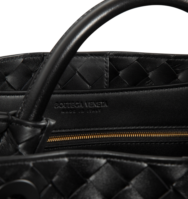 Image 4 of 4 - BLACK - BOTTEGA VENETA Andiamo Bag featuring top handle bag in supple Intrecciato leather with signature knot detail, sliding cross-body strap, compartmented interior with one zippered pocket, two open pockets and magnetic closure. 9.8 x 12.6 x 4.3. Lambskin. Made in Italy. 