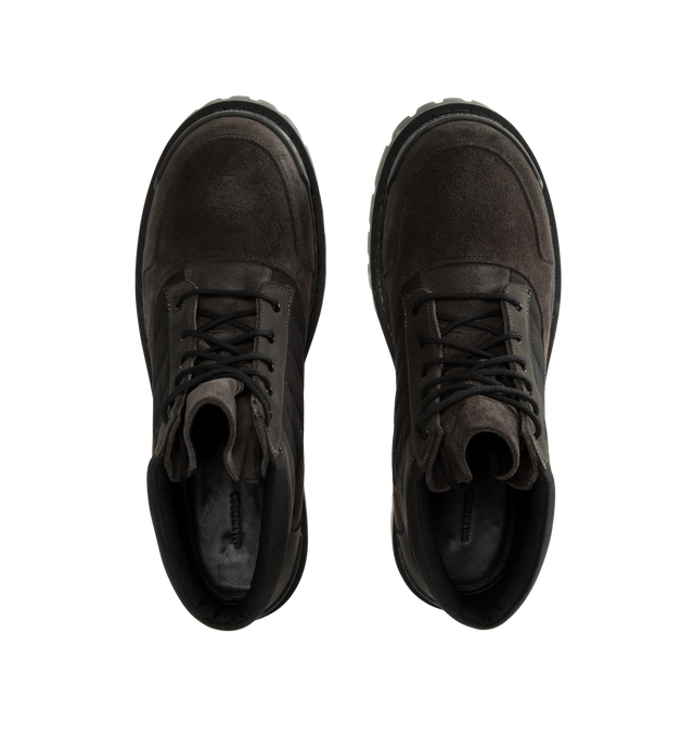 Image 4 of 4 - BROWN - Balenciaga Men's Combat Strike Low Boot is crafted from nubuck calfskin, suede calfskin, and cotton canvas and features an extra-round toe, a six-eyelet lace-up vamp, visible topstitching, and a worn-effect finish. Designed with a thick toothed rubber outsole, this low-profile combat boot is finished with Balenciaga logo detailing at the exterior, front, and back. Main Material: Calfskin leathers and Sole: TPU, Polyurethane. Heel Height: 20 mm / 0.8 in. Made in Italy. 